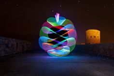 a colorful light painting on the side of a road