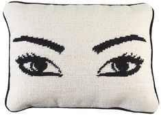 a white pillow with an eye drawn on the front and side of it's face