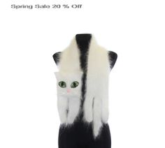 a black and white cat with green eyes on it's hind legs, hanging from a mannequin