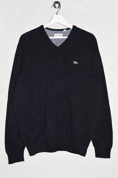 "Lacoste v-neck sweater in black. - Size tag: Please always check measurements before buying. Tag reads Men's XL, but fits like Men's L. - Measurements (laying flat): Pit to Pit: 21.5\" Length: 27\" Sleeve: 25\" Pit to Cuff: 19\" Across the shoulders: 17.5\" -Wear: /Please see images for details/ Good used condition. Slight color fading at places. - Fabric: Cotton *All of our items are preloved pieces so some signs of natural wear and age are to be expected. Please look through the photos carefully to check if the condition is to your satisfaction. *All efforts are made to show any defects however small imperfections may be missed. *We try to describe the sizes as accurately as possible, but please keep in mind that sizes nowadays can differ to sizes used back then. Please note the measure Casual Black V-neck Sweater, Black V-neck Cotton Sweater, Cotton V-neck Sweater With Ribbed Cuffs, Black Casual V-neck Sweater With Ribbed Cuffs, Black Cotton V-neck Sweater, Black Cotton V-neck Winter Sweater, Black Cotton V-neck Sweater For Winter, Sporty Cotton V-neck Sweater, V Neck Sweater Men