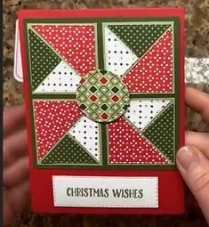 someone is holding up a christmas card in their hand with the words, christmas wishes on it