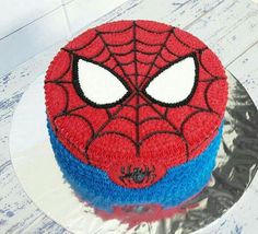 a spiderman cake is sitting on a plate