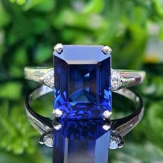 5.08 Carat Lab-grown Dark Blue Sapphire & Natural Diamonds 14k Solid Gold Ring Material: 14k Solid Gold Approximate Weight: 3.2 Grams Band Width Approximately 1.5mm Gemstone: Lab-grown Sapphire   Color: Very Dark Blue (Inky Blue) Shape: Emerald Cut Dimensions: 10.00x8.00 mm Approximate Carat Weight: 5.00 Carat Diamonds: Natural  Shape: Round Color: G Clarity: SI2 Total Carat Weight about: 0.08 Carat Approximate Total Carat Weight: 5.08 Carat Ring Quantity: One Ring Condition: New Made in Los Angeles, CA Delivered in an elegant jewelry box 💜Please do not hesitate to ask any questions and we will be happy to assist You 💜 Luxury Hallmarked Emerald Cut Sapphire Ring, Luxury Hallmarked Emerald-cut Sapphire Ring, Luxury Radiant Cut Sapphire Promise Ring, Luxury Lab-created Emerald Cut Sapphire Ring, Luxury Lab-created Sapphire Emerald-cut Diamond Ring, Luxury Emerald-cut Lab-created Sapphire Ring, Blue Sapphire Engagement Ring, Sapphire Engagement Ring Blue, Sapphire Color