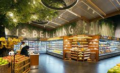 the inside of a grocery store with fruits and vegetables