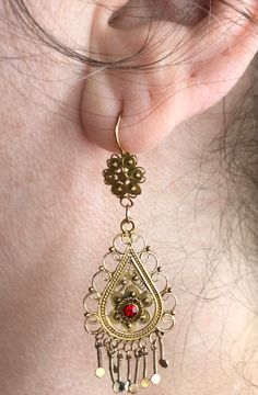 "A beautiful and elaborate pair of vintage cannetille earrings. These outstanding earrings are made of buttery 10k yellow gold (not marked but acid tested positive) and are crafted with fine cannetille wirework. Each earring is comprised of a two-dimensional link that is intricately layered and hangs from a decorative surmount. Delicate beadwork, twisted rope wirework, and swirled floral accents decorate the earrings and fringed accents dangle freely from the bottom. The surmounts have a complim Traditional Yellow Gold Earrings With Historical Design, Vintage Ceremonial Earrings With Intricate Design, Ceremonial Vintage Earrings With Intricate Design, Yellow Gold Earrings With Historical Design As Gift, Antique Filigree Earrings For Ceremonial Occasions, Victorian Yellow Gold Earrings With Intricate Design, Ornate Historical Design Earrings For Wedding, Ornate Historical Wedding Earrings, Vintage Earrings With Intricate Design For Celebrations