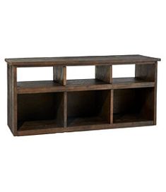 a wooden shelf with three cubbys on top