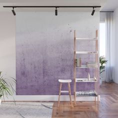 a purple and white ombreed wall mural in a living room with wooden floors