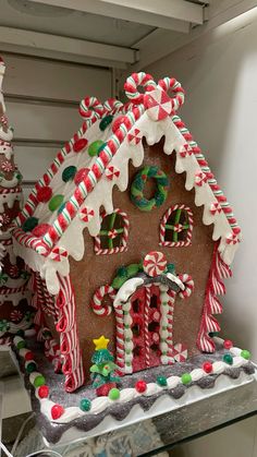 a gingerbread house decorated with candy canes and candies