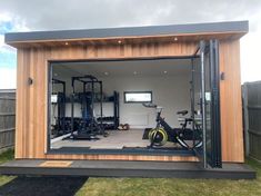 a home gym with exercise equipment in the back ground and an open door to it