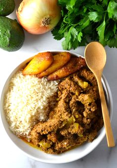 a white bowl filled with rice, meat and veggies next to an avocado