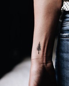 a small pine tree tattoo on the wrist