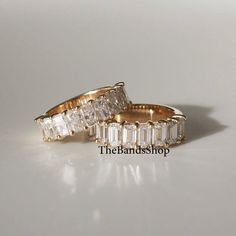 two gold wedding rings with baguettes and diamonds