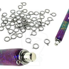 a purple and blue pipe with silver rings on it next to a metal chain link