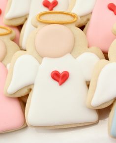 decorated cookies in the shape of angels with hearts