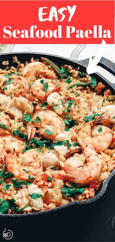 an easy seafood paella recipe in a cast iron skillet with parsley sprinkled on top