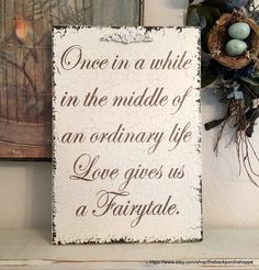 a sign that says, once in a while in the middle of an ordinary life love gives us a fairy tale