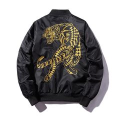 Our Tiger Bomber Jacket – a fierce and fashionable addition to your wardrobe that combines style with a bold statement. *Jacket runs small so take a look at our sizing guidelines Key characteristics of this distinctive piece: Striking Tiger Embroidery: The jacket features a meticulously embroidered tiger motif, adding a bold and eye-catching element to your outfit. Versatile Bomber Silhouette: Designed with a classic bomber jacket silhouette, offering a versatile and contemporary look suitable f Golden Tiger, Pilot Jacket, Fashion Stand, Style Japonais, Cooler Look, Embroidered Jacket, Short Jacket, Black Jacket, Jacket Style