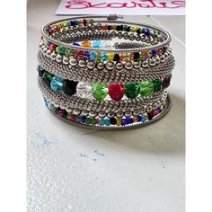 This Wrap Bracelet features colorful beads and an oxidized finish. The unique design allows for versatility in styling, adding a touch of color and texture to any outfit. Crafted with high-quality materials, it is a must-have accessory for any fashion-forward individual. One size fits all. Festival Multicolor Metal Beaded Bracelets, Festival Bracelets With Colorful Metal Beads, Multicolor Metal Beaded Bracelets, Festival Multicolor Bracelets With Silver Beads, Multicolor Silver Beads Bracelets For Festival, Multicolor Silver Beaded Bracelets For Festivals, Multicolor Festival Bangle Bracelet, Bohemian Multicolor Metal Beaded Bracelets, Multicolor Beaded Cuff Bracelet For Festivals