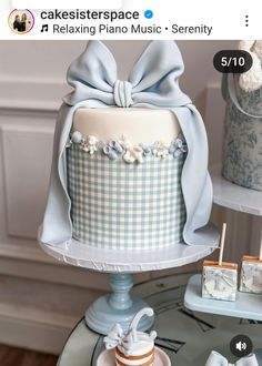 the cake is decorated with blue and white checkered fabric on it's sides