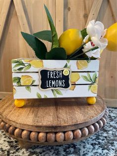 fresh lemons in a wooden crate with flowers