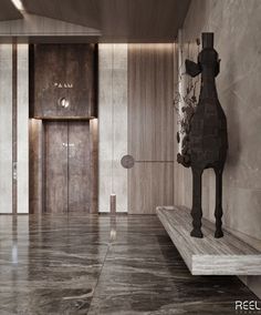 a horse statue sitting on top of a wooden bench in front of a wall mounted elevator