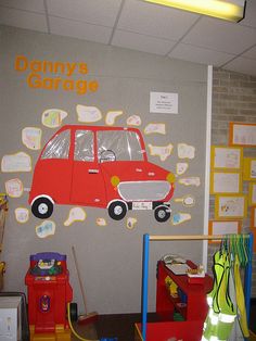 the children's playroom is decorated with toys and wall decals, including a red car