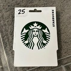 the starbucks logo is on top of a white card holder that says, 25 cents