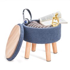 a blue ottoman with headphones and books in it