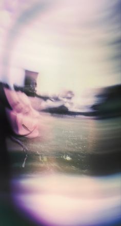 blurry photograph of a woman's face in the middle of an abstract photo