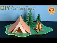 an origami camper and tent on a table with the words diy camping scene