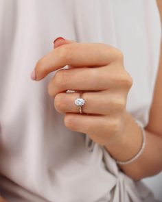 a woman's hand with a diamond ring on it