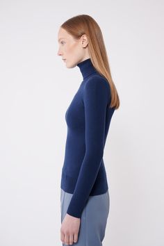 Everyone's staple: a flattering, fitted turtleneck in soft peachskin. Our signature peachskin classics are a wardrobe staple you'll want to wear on repeat. They stand out for their softness, simplicity, and comfort. Not only are they stretchy and perfectly form-fitting, but they also have slight compression properties that feel and look like shape wear. With their carved waist they won't bunch, web, or ride up. The dense and compact peachskin fabrication allows the wearer to go bra-less or layer Elegant Stretch Turtleneck In Solid Color, Elegant High Stretch Turtleneck With Funnel Neck, Elegant High Stretch Turtleneck For Fall, Elegant High Stretch Turtleneck, Classic Fitted Funnel Neck Turtleneck, Classic Fitted Turtleneck With Funnel Neck, Classic Stretch Fine Knit Turtleneck, Classic Stretch Turtleneck For Workwear, Elegant Stretch Fine Knit Turtleneck