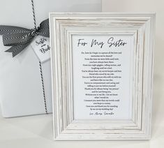 a white frame with a poem on it next to a card and a gift bag