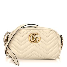 This is an authentic GUCCI Calfskin Matelasse Small GG Marmont Chain Shoulder Bag in White. This stylish shoulder bag is made of soft calfskin leather in off white. This shoulder bag features an antiqued gold chain and leather shoulder strap, and a Gucci GG logo on the front. The top zipper opens to a beige microfiber interior with a patch pocket. White Gucci Shoulder Bag With Chain Strap, Classic Gucci Cream Bag, Classic Cream Gucci Bags, Elegant Gucci Soft Leather Bags, Gucci Luxury Soft Leather Shoulder Bag, Luxury Gucci Shoulder Bag In Soft Leather, Luxury Gucci Soft Leather Shoulder Bag, Gucci Cream Leather Shoulder Bag, Classic Cream Gucci Shoulder Bag