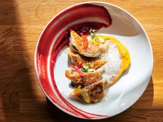 a white plate topped with food on top of a wooden table