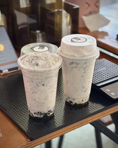 two drinks sitting on top of a table next to each other