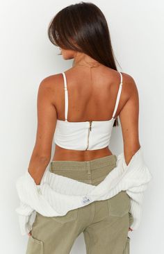 * White Cropped Top 
 * This extremely flattering crop () will be your next go to! Such a versatile piece -  pair with jeans () for a morning outing to the markets, or a white skirt () for a date night look. 
 * 
 
 * Cropped  
 * Bustier style  
 * Faux buttons down centre  
 * Underwire cups  
 * Adjustable spaghetti straps  
 * Gold zip at back  
 * Unlined  
 * Lightweight material with no stretch Divine White, Prom Midi Dress, Summer Playsuit, Sweater Crop, Strapless Tops, Crop Top Sweater, White Skirt, One Shoulder Tops, White Crop Top