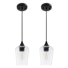 two clear glass pendant lights hanging from the ceiling, one light is black and the other is