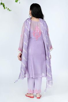 Lilac mulmul chanderi kurta with pink thread embroidery, mirror work embellishment, pleated front panel and side slits. Paired with a cotton embroidered Pakistani pants, lehriya crinkled dupatta and sleeveless slip.
Component: 4
Pattern: Embellishment and Embroidered
Type Of Work: Mirror and Thread Work
Neckline: Notched Round Neck
Sleeve Type: Three Quarter
Fabric: Kurta: Mulmul Chanderi, Cotton
Color: Purple
Other Details: 
Tassels details on kurta)
Gota work stripes on dupatta
Pom-Poms tassel Spring Chanderi Dupatta With Self Design, Spring Handloom Chanderi Kurta, Purple Chikankari Embroidered Dupatta For Spring, Purple Spring Festive Dupatta, Spring Festive Purple Dupatta, Handloom Mulmul Sets, Purple Spring Festival Dupatta, Mulmul Kurta With Sheer Dupatta, Semi-stitched Purple Kurta With Mirror Work