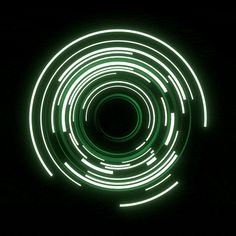 a circular light painting in the dark with green and white lights on it's side