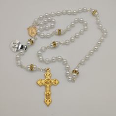 "A beautiful rosary made of high quality pearl beads. Fully handcrafted with each bead individually cut, polished and drilled by expert craftsmen. This rosary is not only a long lasting piece of jewellery but also the perfect gift for yourself or someone special in your life. The Our Lady Fatima with the three Little Shepherds at Her feet Center on one side and water from the fountain of the Sanctuary of Fatima on the other.  With this special center piece and the very original Crucifix makes th White Crucifix Pearl Necklace As A Gift, Silver Pearl Rosary With 8mm Beads, Elegant Beaded Rosary For Jewelry Making, White Cross Rosary For Jewelry Making, Pearl White Rosary With 8mm Beads As Gift, Pearl Rosary Bracelet With 8mm Round Beads, White Pearl Rosary As A Gift, Elegant Pearl Rosary With 8mm Beads, White Pearl Rosary As Gift