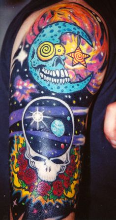 a man's arm with tattoos on it and an image of a skull in the space