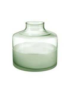 a glass vase sitting on top of a white table