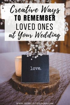 a table with flowers and a sign that says creative ways to remember love ones at your wedding