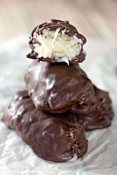 three chocolate covered donuts stacked on top of each other