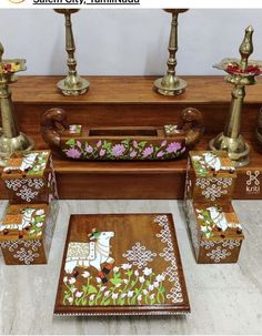 a wooden table topped with lots of vases next to candles and other decor items