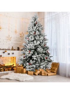 a white christmas tree with presents under it