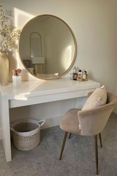 a white desk with a round mirror on it and a chair in front of it