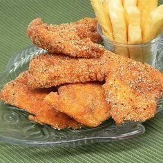 fried fish and french fries on a glass plate