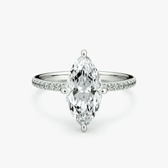 an oval cut diamond ring with pave set shoulders